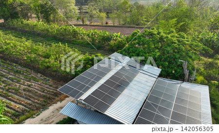 Solar panels powering a sustainable organic farm with productive crop fields, regenerative agriculture, renewable energy systems, and eco friendly food production in rural landscape. Clean energy. Solar panels powering a sustainable organic farm with productive crop fields, regenerative agriculture, renewable energy systems, and eco friendly food production in rural landscape. Clean energy. 142056305