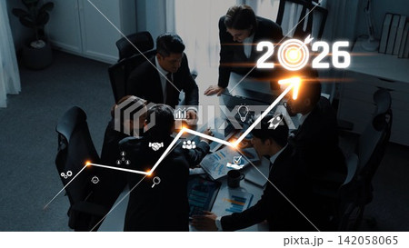 Business team collaborating on growth strategy with data analysis and projections for 2026 in a modern office environment. Raster 142058065