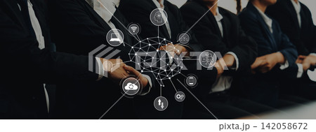 Business professionals in suits sitting in a conference room with digital network overlay and technology icons representing innovation and connectivity Trope 142058672