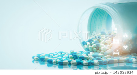 Blue and white capsules pills spilled out of white plastic bottle with medical and healthcare icon. Medical and healthcare concept. Hospital care and health insurance service. Hospital care budget. Blue and white capsules pills spilled out of white plastic bottle with medical and healthcare icon. Medical and healthcare concept. Hospital care and health insurance service. Hospital care budget. 142058934