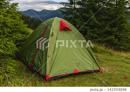 Camping in the Carpathians with a tent in the valley near Kukul Camping in the Carpathians with a tent in the valley near Kukul 142059896