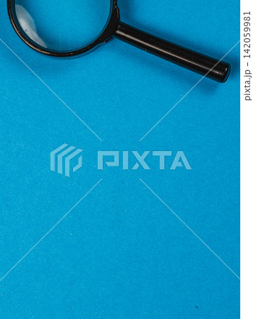 Magnifying glass on blue background for inspection and research Magnifying glass on blue background for inspection and research 142059981
