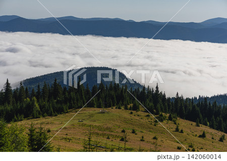 Mountains in Carpathians show valley and forest under cloud cover Mountains in Carpathians show valley and forest under cloud cover 142060014