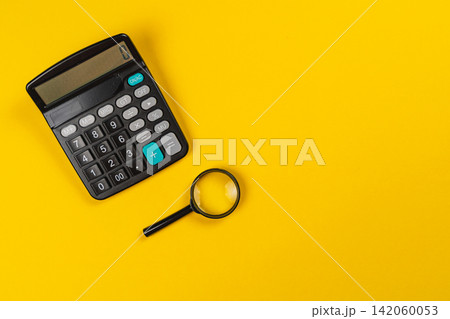 Tools for financial calculation and analysis on a yellow background Tools for financial calculation and analysis on a yellow background 142060053