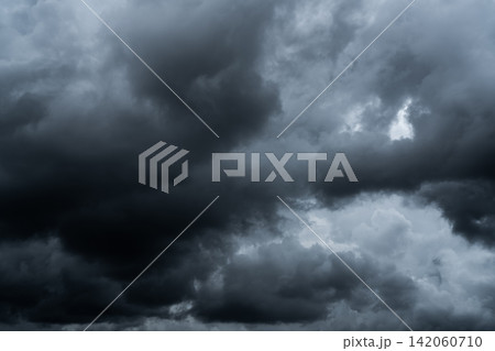 Dark dramatic sky and clouds. Background for death and sad concept. Gray sky and fluffy white clouds. Thunder and storm sky. Sad and moody sky. Nature background. Dead abstract background. Cloudscape. 142060710