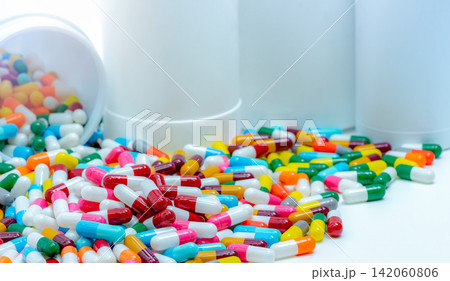 Pile of antibiotic capsule pills with plastic bottle. Antibiotic drug resistance. Antimicrobial drug overuse and smart use concept. Pharmaceutical industry. Pharmacy products. Prescription drugs. Pile of antibiotic capsule pills with plastic bottle. Antibiotic drug resistance. Antimicrobial drug overuse and smart use concept. Pharmaceutical industry. Pharmacy products. Prescription drugs. 142060806