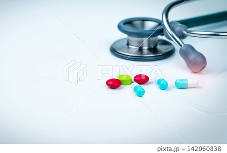 Stethoscope, capsule, and tablets pills on doctor table or nurse desk. Health checkup. Medical healthcare and medicine background. Physician tool for patient diagnosis. Cardiology doctor equipment. Stethoscope, capsule, and tablets pills on doctor table or nurse desk. Health checkup. Medical healthcare and medicine background. Physician tool for patient diagnosis. Cardiology doctor equipment. 142060838
