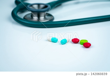 Stethoscope, capsule, and tablets pills on doctor table or nurse desk. Health checkup. Medical healthcare and medicine background. Physician tool for patient diagnosis. Cardiology doctor equipment. 142060839