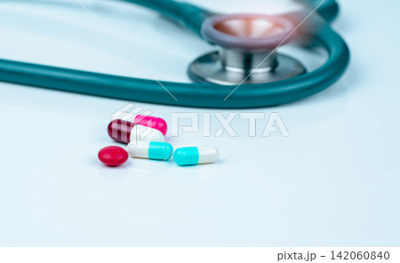 Stethoscope, capsule, and tablets pills on doctor table or nurse desk. Health checkup. Medical healthcare and medicine background. Physician tool for patient diagnosis. Cardiology doctor equipment. Stethoscope, capsule, and tablets pills on doctor table or nurse desk. Health checkup. Medical healthcare and medicine background. Physician tool for patient diagnosis. Cardiology doctor equipment. 142060840