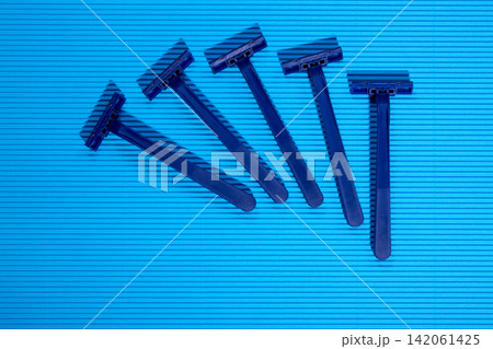 Shaving razors on a colored background Shaving razors on a colored background 142061425