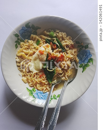 Indonesian Instant Noodles with Egg and Vegetables in Floral Bowl Indonesian Instant Noodles with Egg and Vegetables in Floral Bowl 142061491