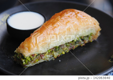 pistachio baklava served on a black plate pistachio baklava served on a black plate 142063640