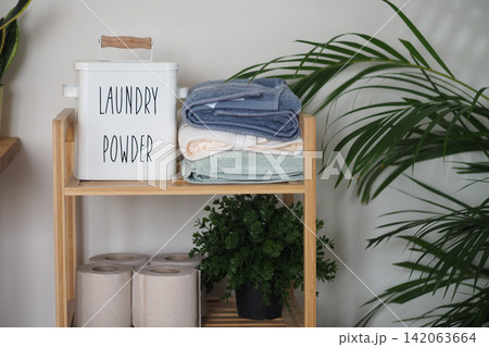 Laundry supplies and towels arranged on a shelf Laundry supplies and towels arranged on a shelf 142063664