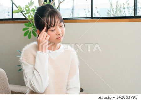 頭痛でこめかみを抑える小学生,中学生の女の子 頭痛でこめかみを抑える小学生,中学生の女の子 142063795