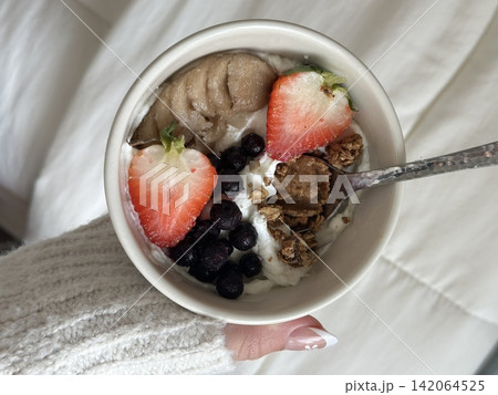 Creamy yogurt bowl topped with fresh fruits and crunchy toppings, offering a smooth texture and refreshing taste. Light, wholesome, and visually appealing, perfect for breakfast or healthy snack. Creamy yogurt bowl topped with fresh fruits and crunchy toppings, offering a smooth texture and refreshing taste. Light, wholesome, and visually appealing, perfect for breakfast or healthy snack. 142064525