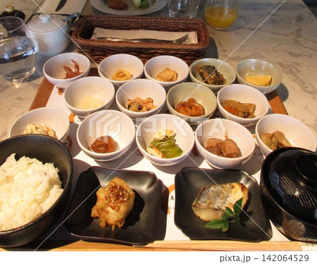 A vibrant spread of Korean food on the table, featuring various banchan (side dishes) like kimchi, pickled vegetables, and seasoned greens. Perfect for food photography, showcasing traditional Korean. A vibrant spread of Korean food on the table, featuring various banchan (side dishes) like kimchi, pickled vegetables, and seasoned greens. Perfect for food photography, showcasing traditional Korean. 142064529