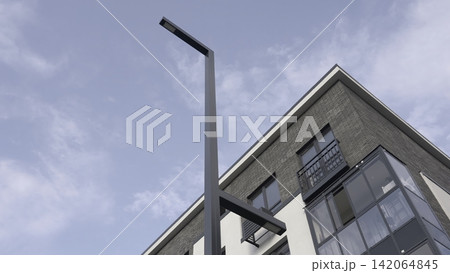 Sleek Metallic Street Support With Dual Horizontal Extensions Alongside Modern City Apartments. Stock Clip 142064845