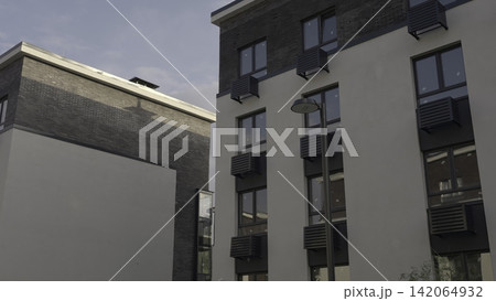 Streetlamp And Structural Elements Evoke Industrial Aesthetic Within Peaceful Neighborhood Setting. Stock Clip Streetlamp And Structural Elements Evoke Industrial Aesthetic Within Peaceful Neighborhood Setting. Stock Clip 142064932