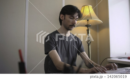 Professional Developer Concentrating On Code With Illuminated Monitor And Ambient Room Glow. Media 142065019