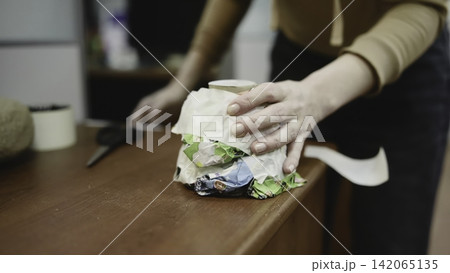 Hands Test Packaging. Careful Examination And Modification Of Recycled Carton Prototype In Workshop Setting . Media 142065135