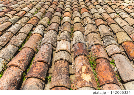 Aged terracotta roof tiles texture on traditional medieval building in Rupit, Catalonia, Spain Aged terracotta roof tiles texture on traditional medieval building in Rupit, Catalonia, Spain 142066324