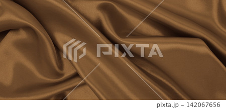 Smooth elegant brown silk or satin luxury cloth texture as abstract background. Luxurious background design. In Sepia toned. Retro style Smooth elegant brown silk or satin luxury cloth texture as abstract background. Luxurious background design. In Sepia toned. Retro style 142067656