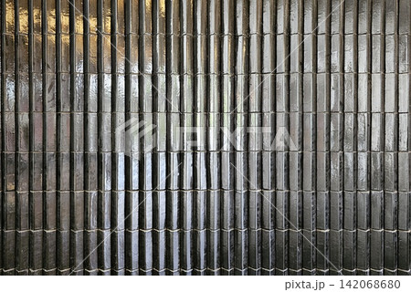 Glossy black tile vertical ribbed wall surface background for professional interior design presentation. Glossy black tile vertical ribbed wall surface background for professional interior design presentation. 142068680