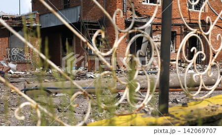 View to destroyed residential buildings at Kharkivska oblast. Ruined houses after bomb attacks on ukrainian territory from russia army. Consequences of russian invasion of Ukraine. Slow motion View to destroyed residential buildings at Kharkivska oblast. Ruined houses after bomb attacks on ukrainian territory from russia army. Consequences of russian invasion of Ukraine. Slow motion 142069707
