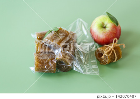 Natural apple pastila in sealed package on green background 142070487