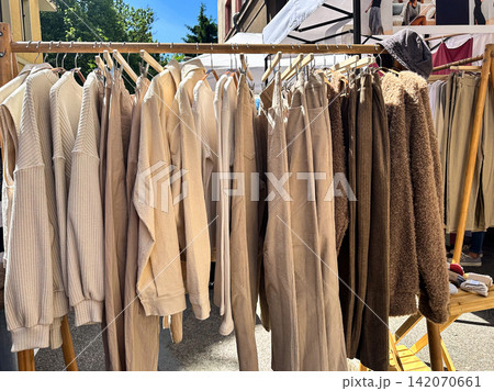 Neutral Beige Clothing Display at Outdoor Fashion Market 142070661