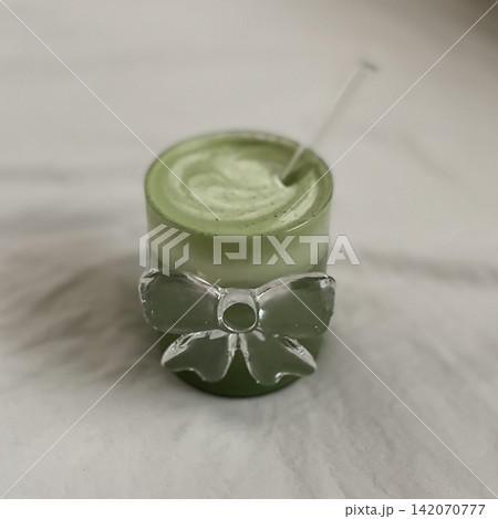 A creamy iced matcha latte with vibrant green tea and smooth milk. Perfectly chilled for a refreshing and energizing drink, offering a balance of earthy matcha and light sweetness. 142070777