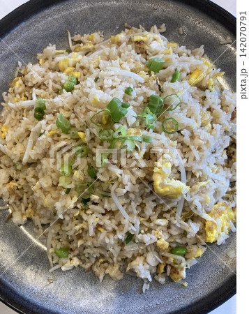nasi goreng or fried rice traditional frying rice dish from indonesia made of Precooked rice fried in a small amount of oil, then spiced up with shallots, garlic, chili and sweet soy sauce. nasi goreng or fried rice traditional frying rice dish from indonesia made of Precooked rice fried in a small amount of oil, then spiced up with shallots, garlic, chili and sweet soy sauce. 142070791