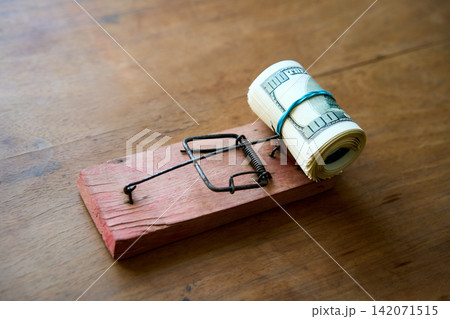Hundred dollar bills caught in wooden mousetrap Hundred dollar bills caught in wooden mousetrap 142071515