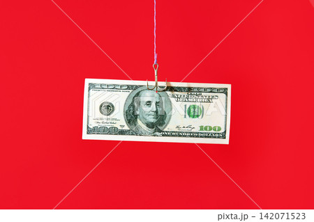 Dollar bill on hook over red background Dollar bill on hook over red background 142071523
