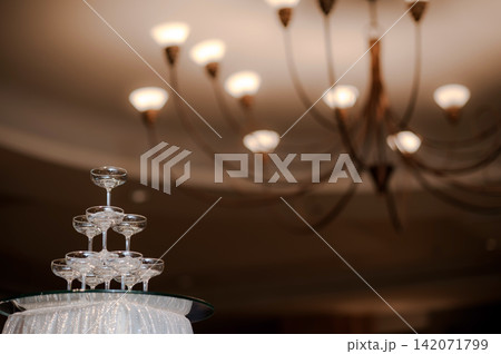 small tower of champagne's glass in wedding reception party small tower of champagne's glass in wedding reception party 142071799