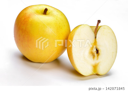 a whole flesh yellow-red orin apple covered with small water droplet and another half isolated in white background with clipping path a whole flesh yellow-red orin apple covered with small water droplet and another half isolated in white background with clipping path 142071845