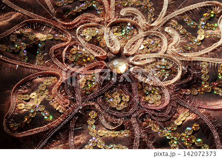 handmade embroidery on brown fabric handmade embroidery on brown fabric 142072373