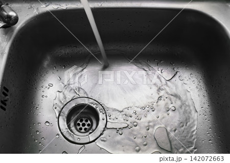 a wet dirty sink after washing many dishes photo may had noise and gain 142072663