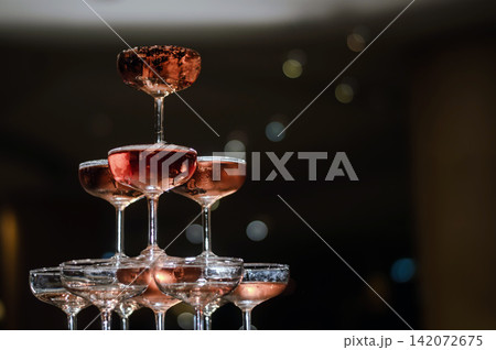 small tower of champagne's glass in wedding reception party small tower of champagne's glass in wedding reception party 142072675