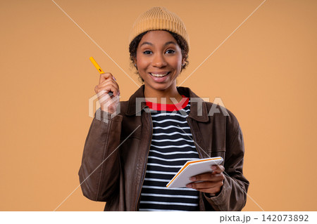 Breakthrough Genius Idea. Happy African Teen Girl Eureka Moment with pen in hands, Pointing it on Breakthrough Genius Idea. Happy African Teen Girl Eureka Moment with pen in hands, Pointing it on 142073892