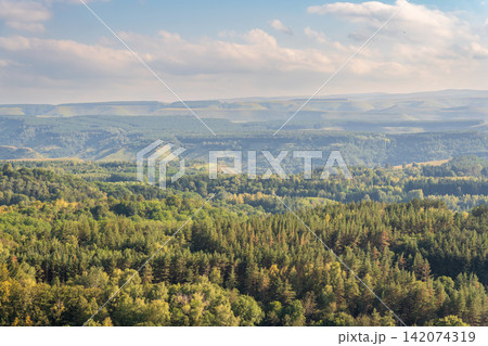 Layers of green mountains and hills in the haze during sunset. Panoramic View of Green hills and Meadow. Layers of green mountains and hills in the haze during sunset. Panoramic View of Green hills and Meadow. 142074319