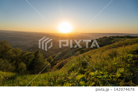 View of the mountains and Kislovodsk from the observation decks of the Kislovodsk Park. Evening sunset over the mountains of Kislovodsk. 142074678