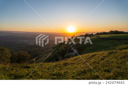 View of the mountains and Kislovodsk from the observation decks of the Kislovodsk Park. Evening sunset over the mountains of Kislovodsk. View of the mountains and Kislovodsk from the observation decks of the Kislovodsk Park. Evening sunset over the mountains of Kislovodsk. 142074681