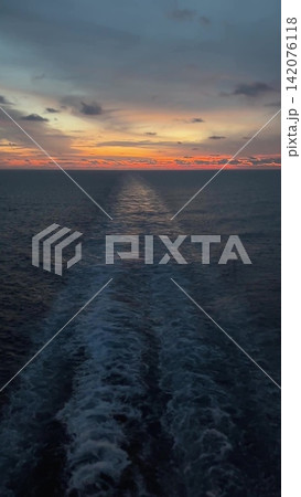 Stunning sunset over calm ocean from cruise ship 142076118