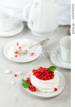 Pavlova dessert with red currant and mint. Pavlova dessert with red currant and mint. 142076845