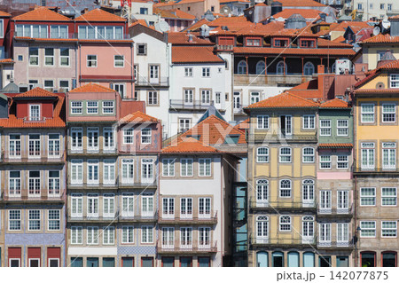 Ribeira houses in Porto, Portugal, a UNESCO World Heritage Site, with sunny walls, terracotta rooftops and traditional windows in Porto Ribeira 142077875