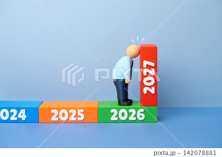 An office worker is facing the New Year 2027. Exhaustion and fatigue from work stress. A difficult end to the year, a decline in vitality. Help in overcoming problems. 142078881