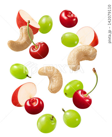 Cashew, red apple slices and cherries flying isolated on white background. Real photography. 142079110