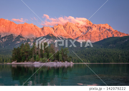 Close up of Maximiliansinsel island at Eibsee lake during sunset glow Close up of Maximiliansinsel island at Eibsee lake during sunset glow 142079222