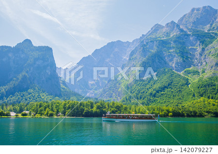 Scenic view of Konigsee lake with boat and Alpine mountains in Germany Scenic view of Konigsee lake with boat and Alpine mountains in Germany 142079227